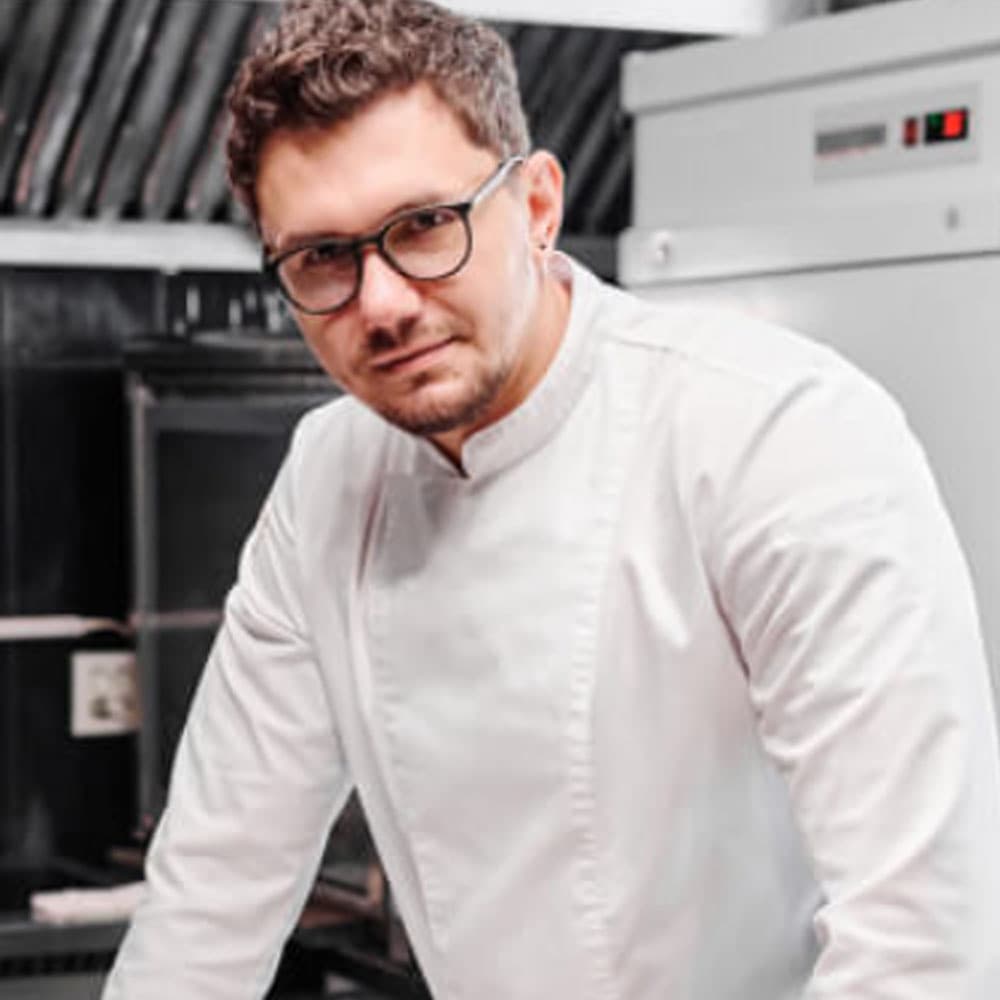 Professional chef client of ASA Web Solutions in a modern kitchen setup.